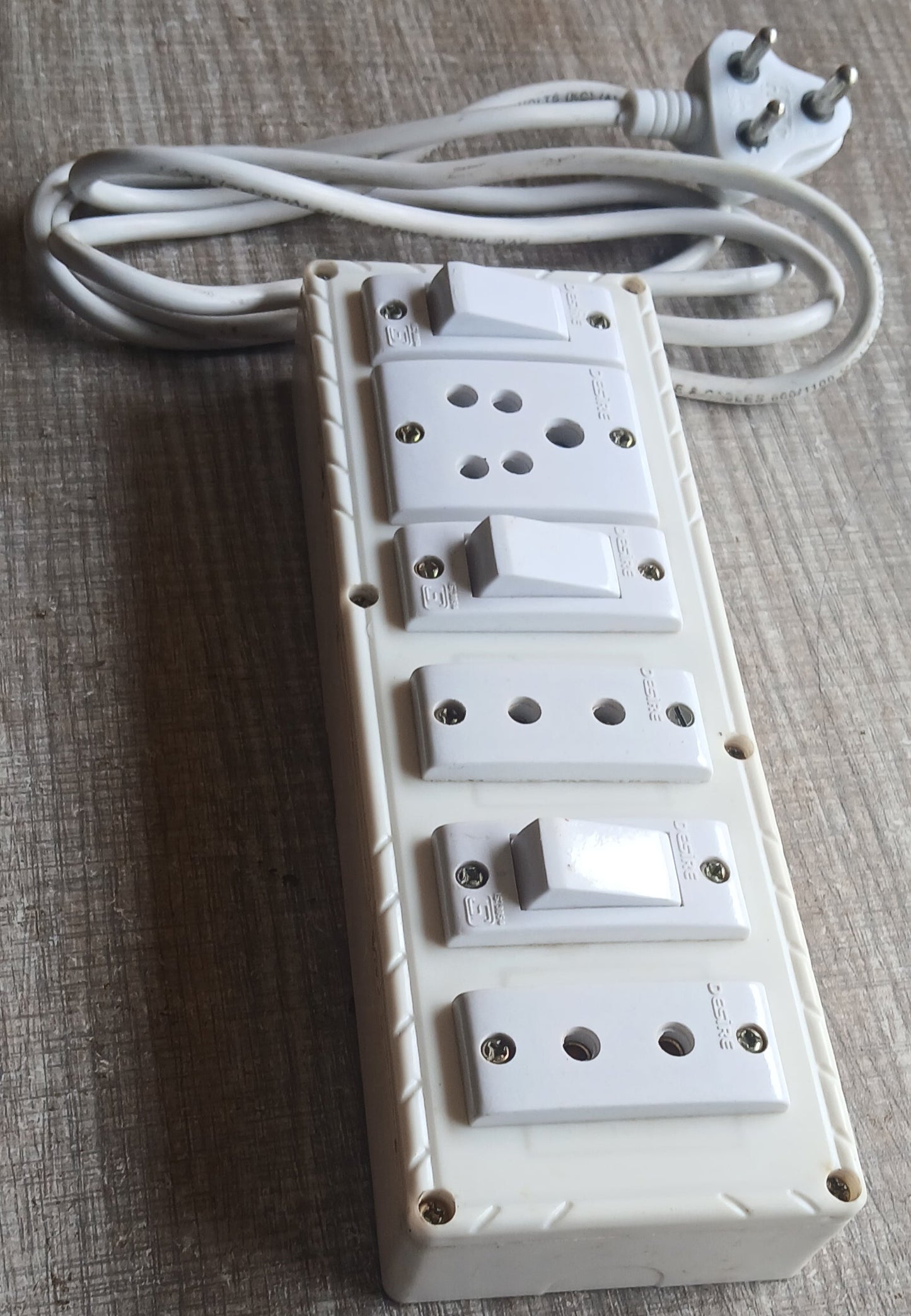 White electrical plug and socket on a textured surface