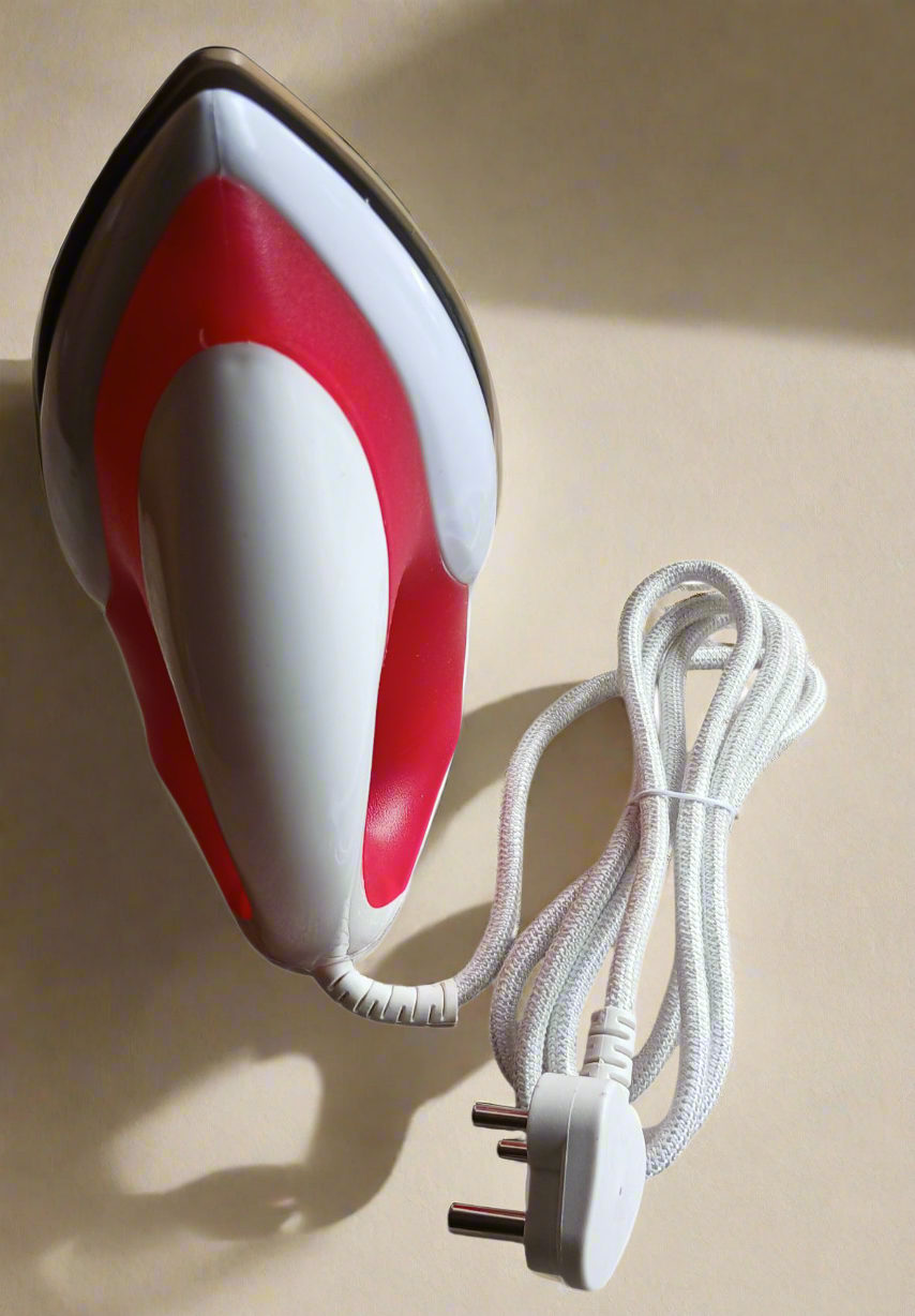 Small red and white iron with a plug on a white background